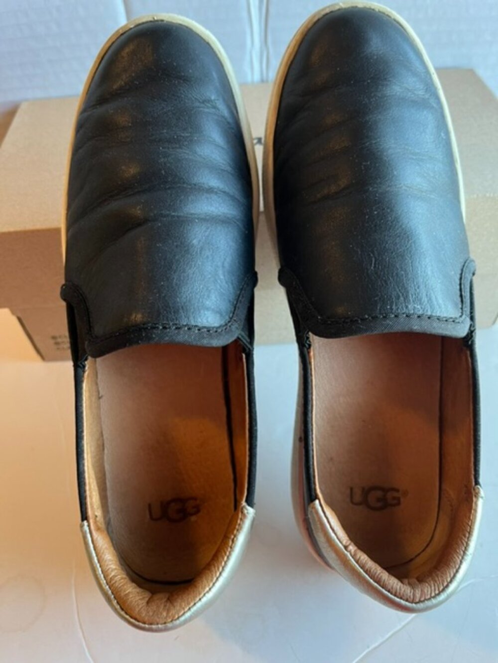 UGG CAS black leather sneaker.